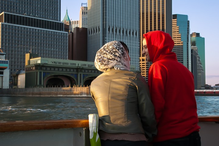 a person standing on a bridge over a body of water