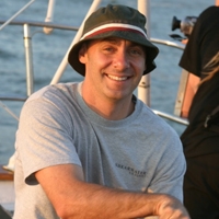 a man holding a fish in the water