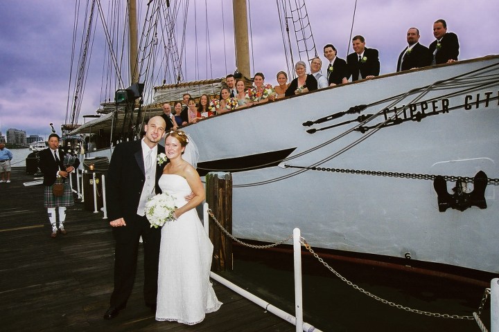 a man and a woman standing on a boat
