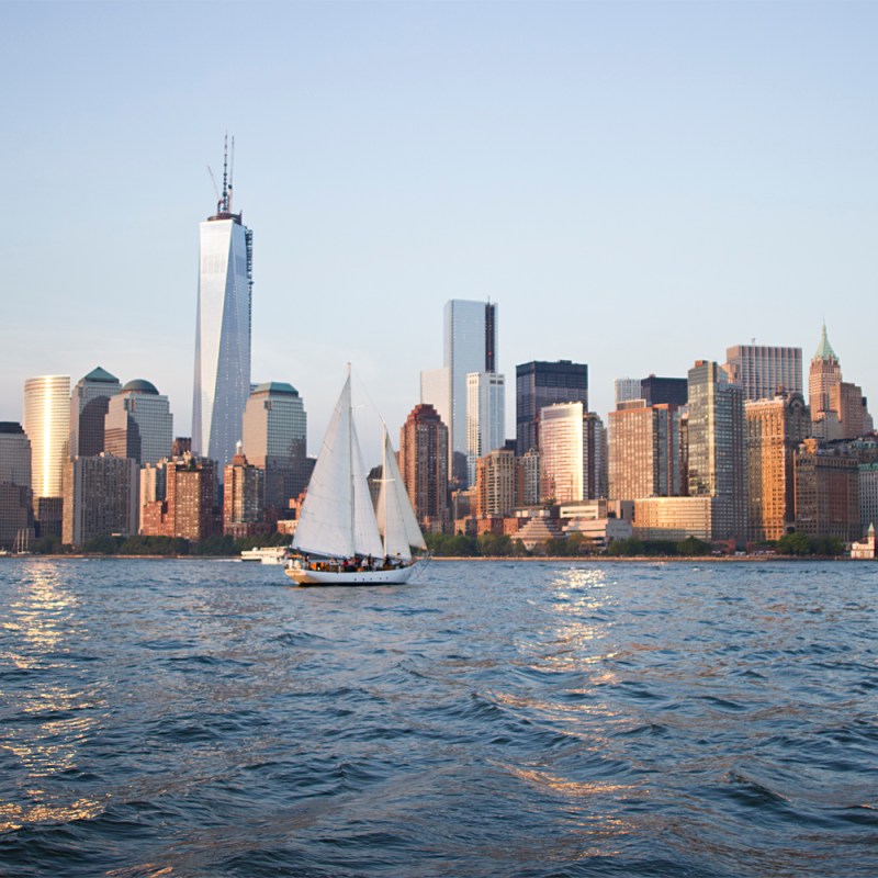 a large body of water with a city in the background
