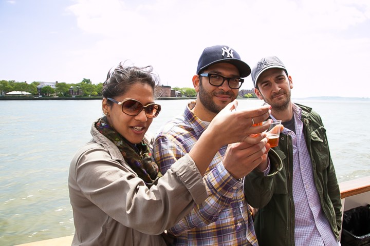 a person wearing sunglasses and standing next to a body of water