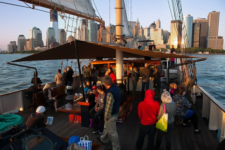 a group of people on a dock next to a body of water