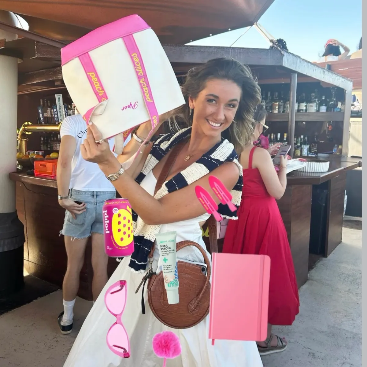 Woman smiling, holding a bag, surrounded by digital pink items overlay at an outdoor bar.