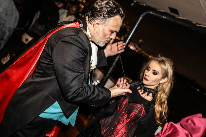 Two people in vampire-themed costumes at a night event.